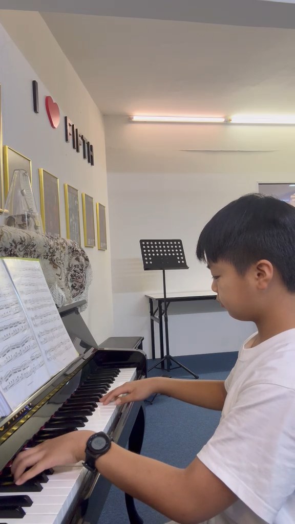 A learner exploring a piece at the piano.