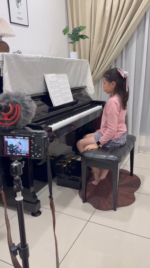 Preparing to share a performance on camera.